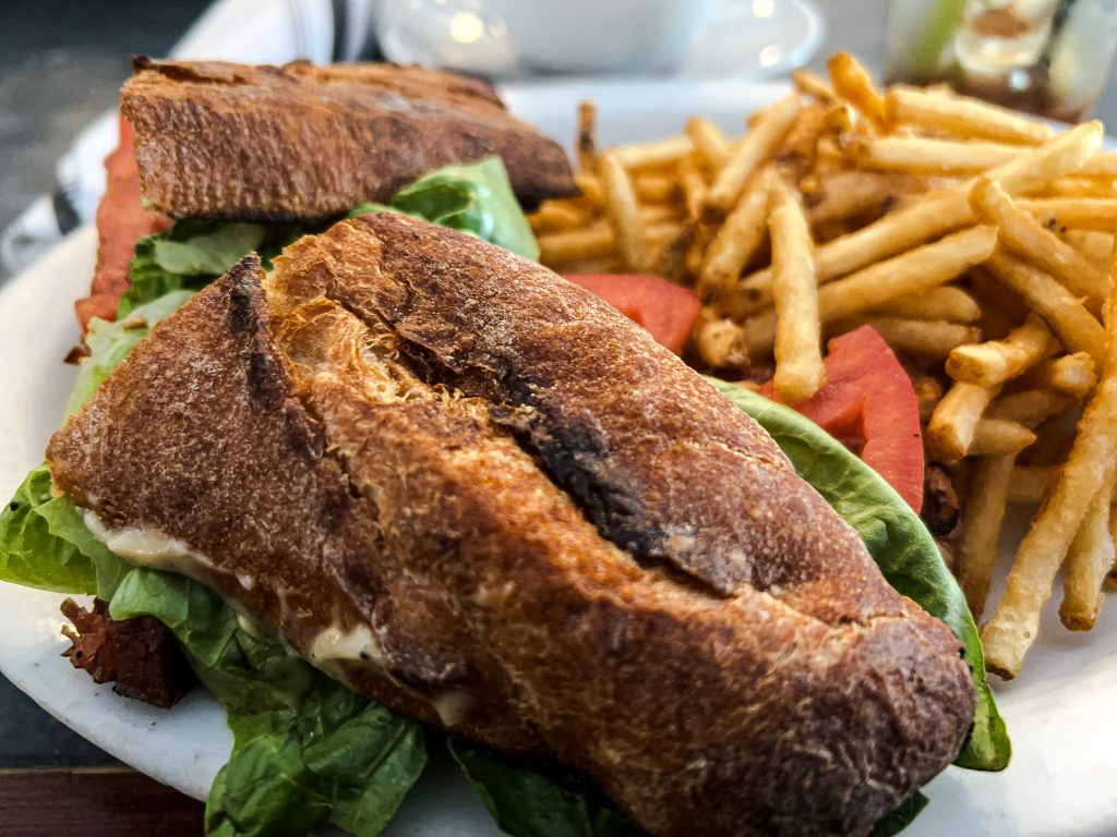 Photograph of a big Bacon-Lettuce-Tomato-Avocado sandwich.