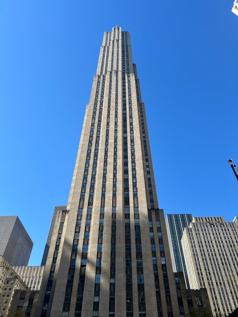 Photograph of the Rockefeller Center taken from the ground, looking up.